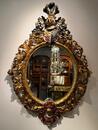 A 19th Century Baroque Revival oval mirror. 