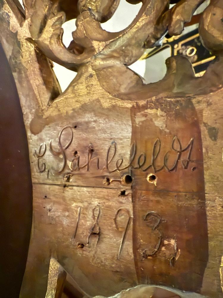 A 19th Century Baroque Revival oval mirror. 