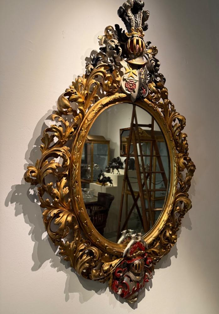 A 19th Century Baroque Revival oval mirror. 
