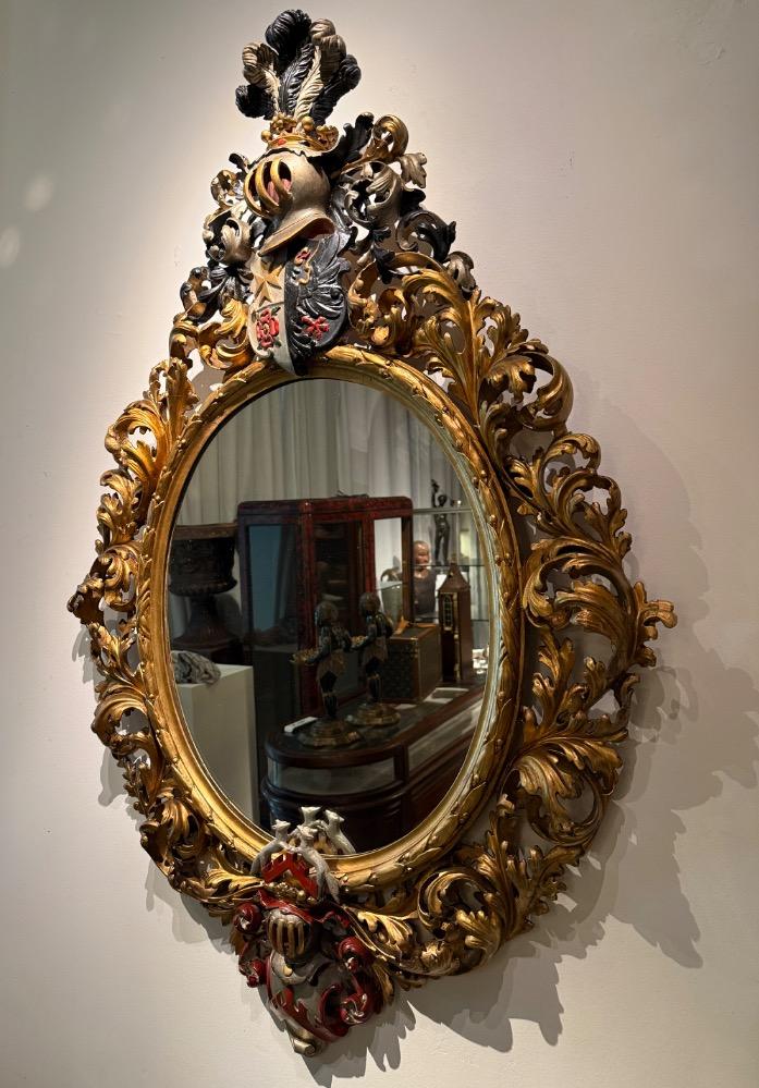 A 19th Century Baroque Revival oval mirror. 