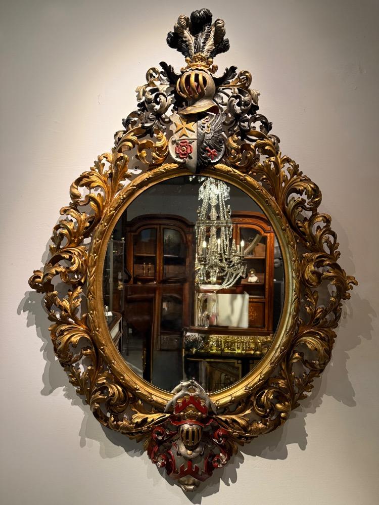 A 19th Century Baroque Revival oval mirror. 