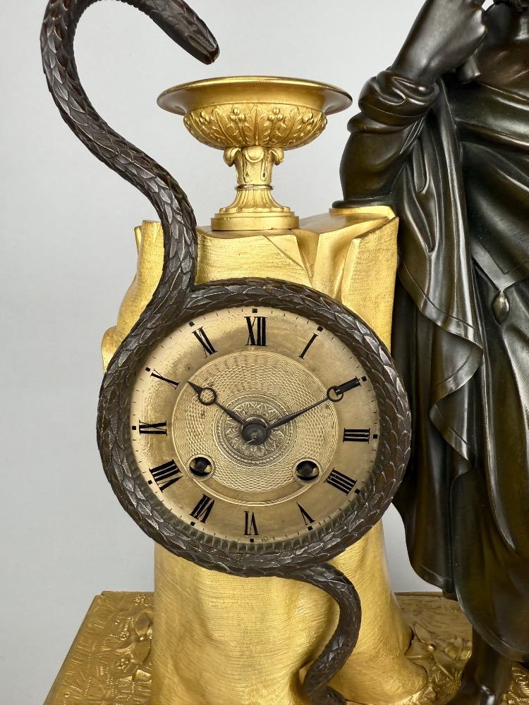 A 19thC. Empire ormolu and patinated bronze mantel clock representing Asclepius
