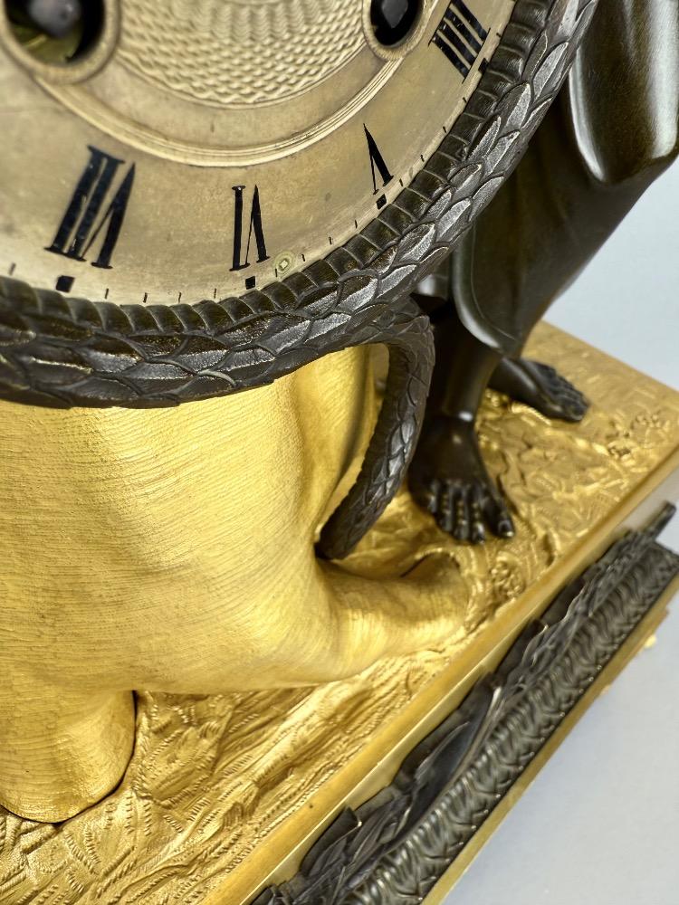 A 19thC. Empire ormolu and patinated bronze mantel clock representing Asclepius