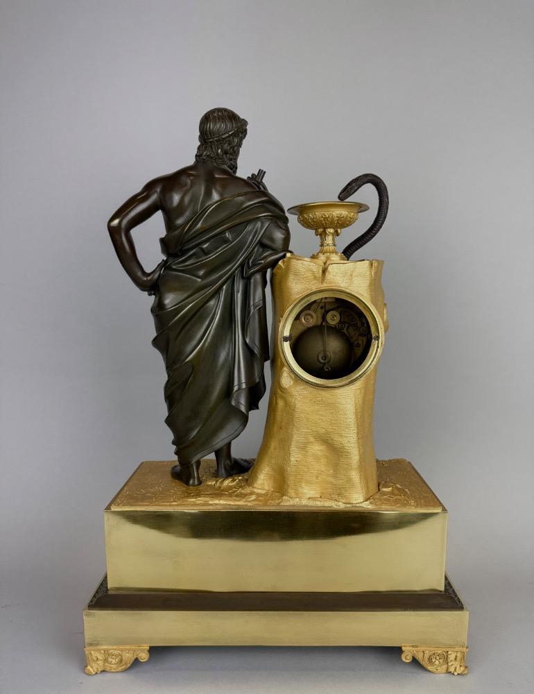 A 19thC. Empire ormolu and patinated bronze mantel clock representing Asclepius