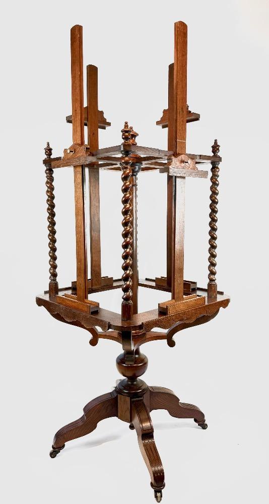 A 19thC. oak four-sided revolving presentation easel.