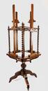 A 19thC. oak four-sided revolving presentation easel.