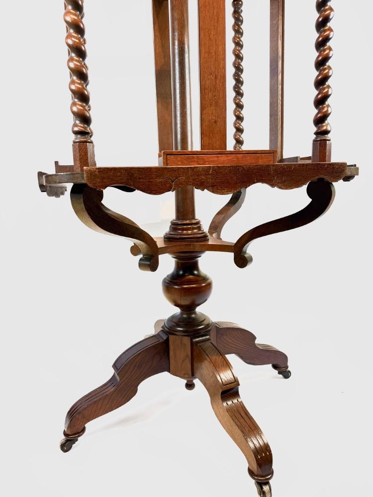 A 19thC. oak four-sided revolving presentation easel.