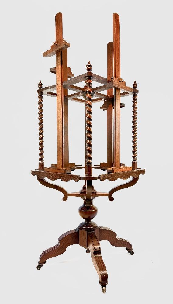 A 19thC. oak four-sided revolving presentation easel.
