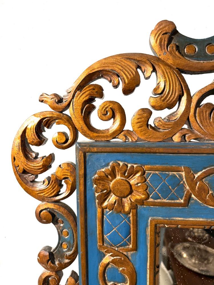 A carved and gilded wooden mirror. 