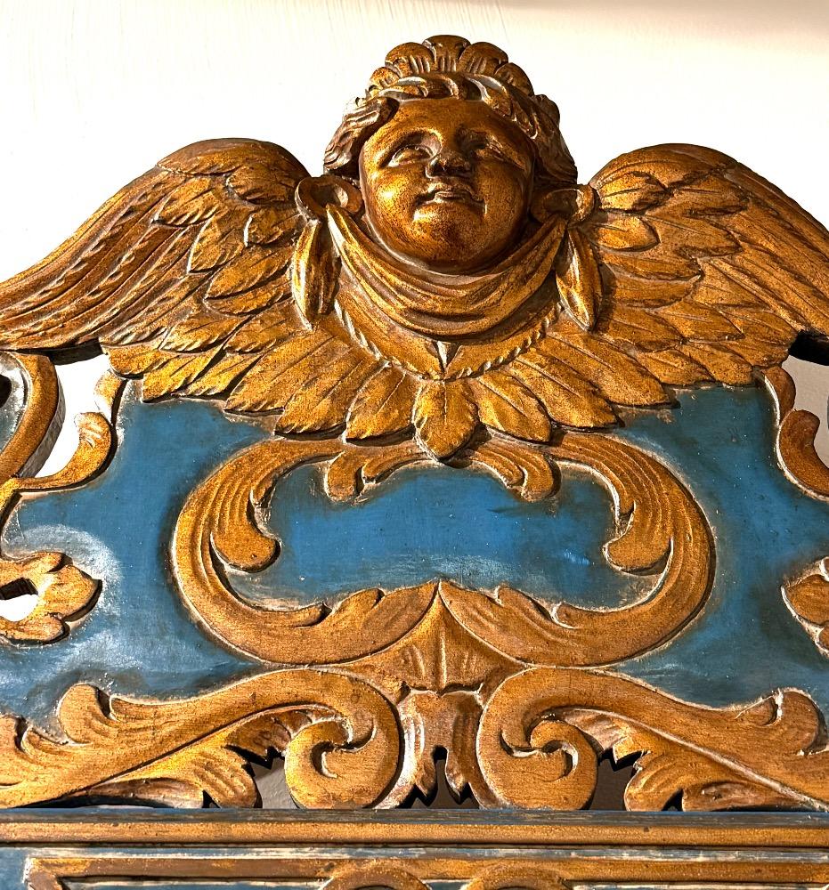 A carved and gilded wooden mirror. 