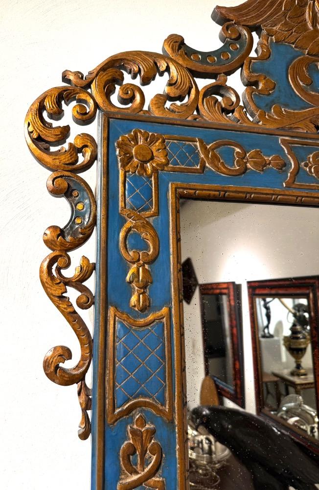 A carved and gilded wooden mirror. 