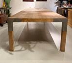 A LARGE DINING TABLE DESIGNED BY CLAIRE BATAILLE AND PAUL IBENS.