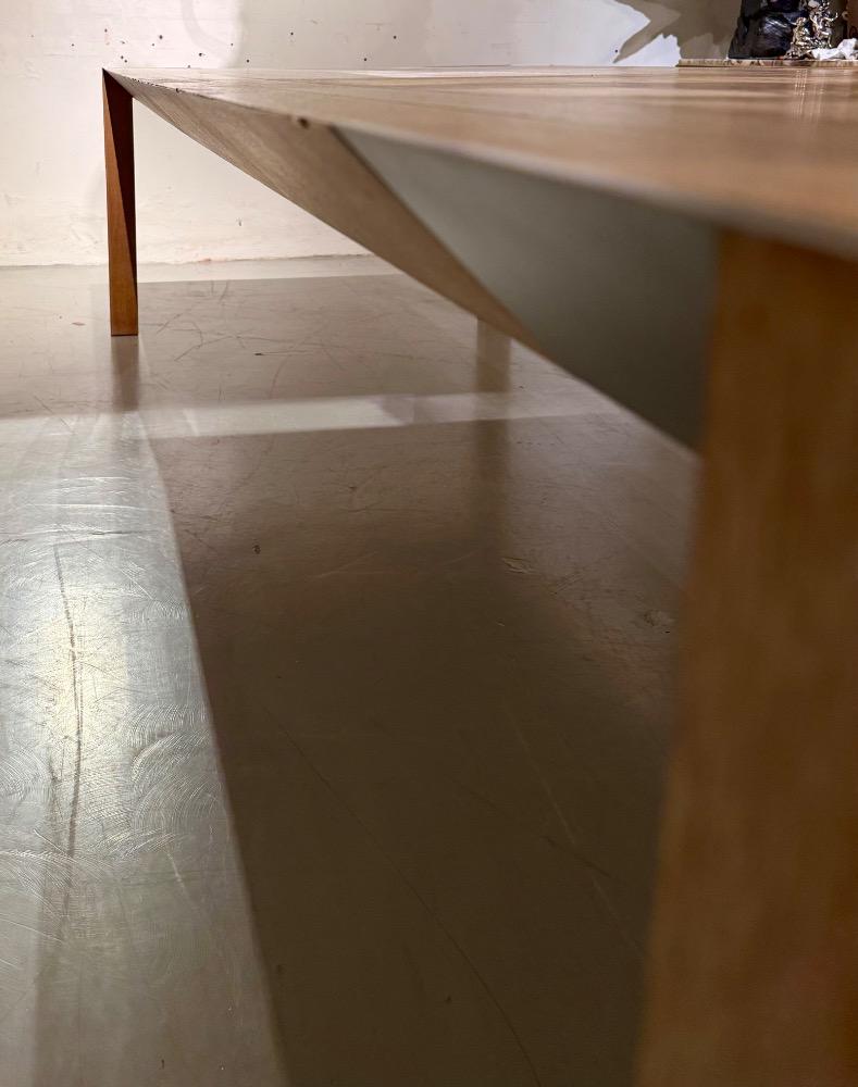 A LARGE DINING TABLE DESIGNED BY CLAIRE BATAILLE AND PAUL IBENS.