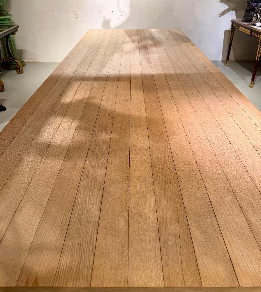 A LARGE DINING TABLE DESIGNED BY CLAIRE BATAILLE AND PAUL IBENS.