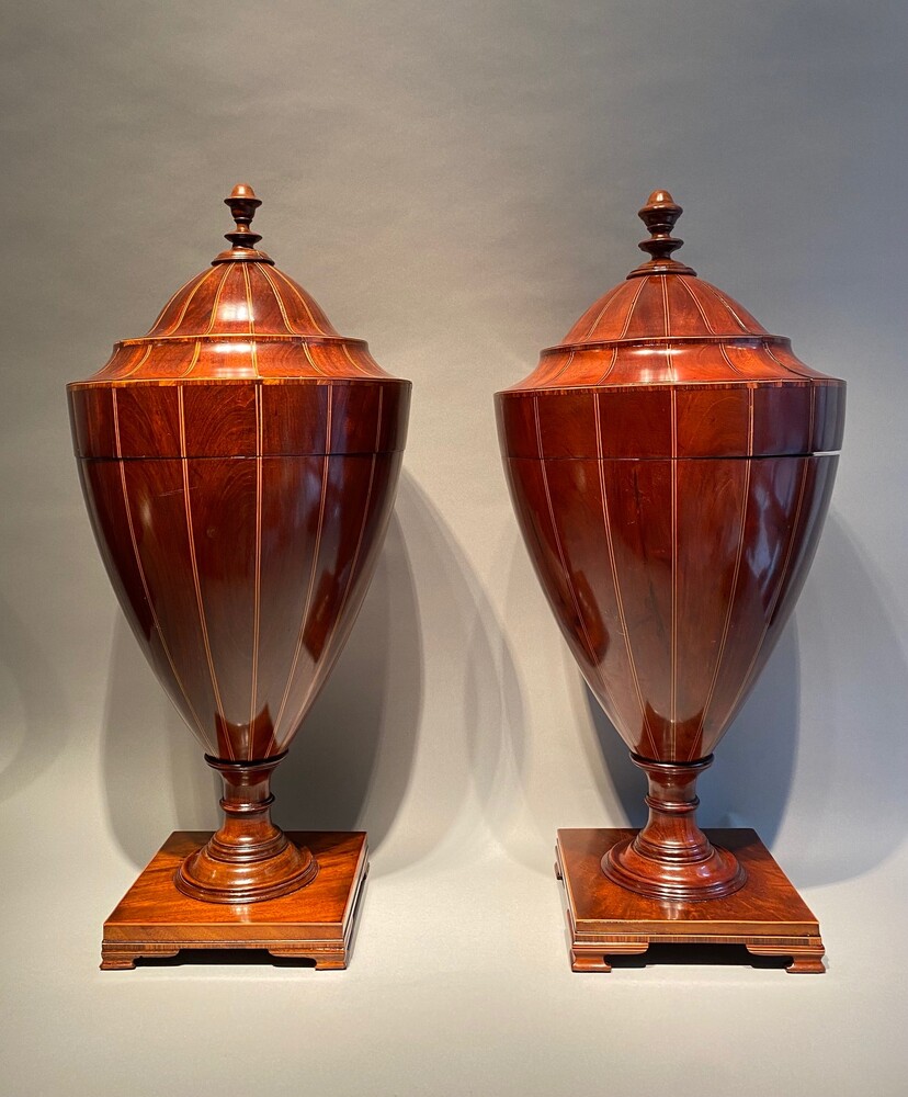 A large matched pair of English mahogany urns 