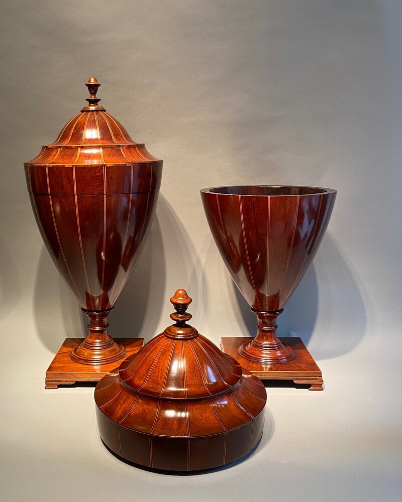 A large matched pair of English mahogany urns 