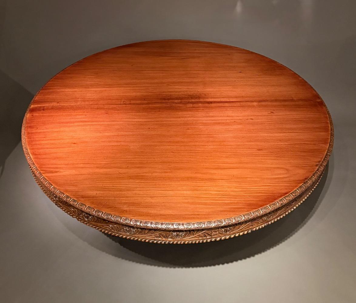 A large round dining table. 12 persons. 