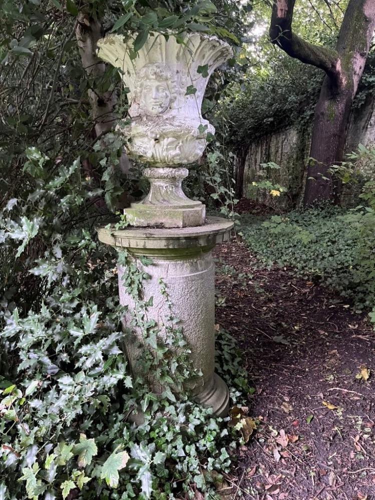 A large stone garden  pedestal