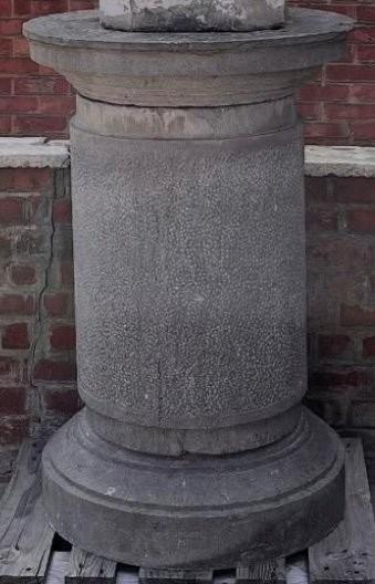 A large stone garden  pedestal
