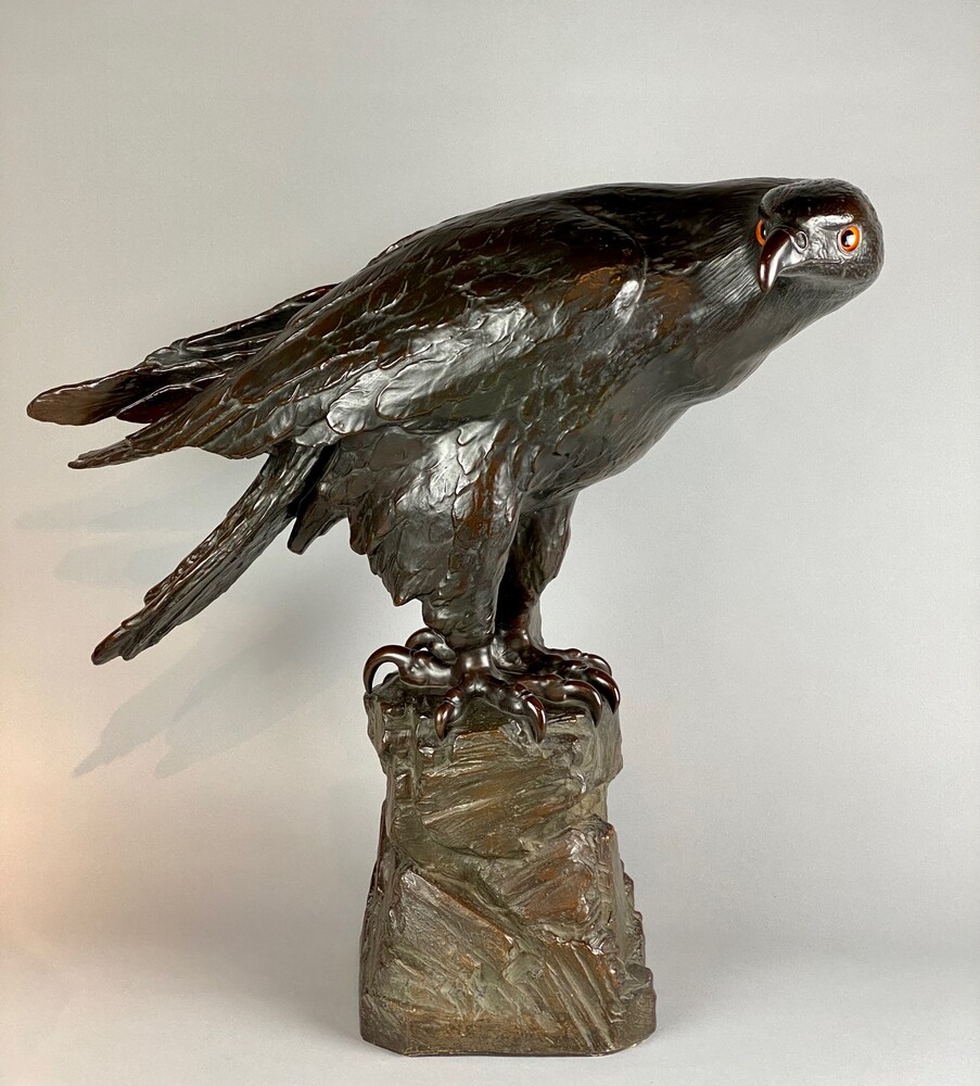 A life size terracotta bronze coloured sculpture of an eagle.