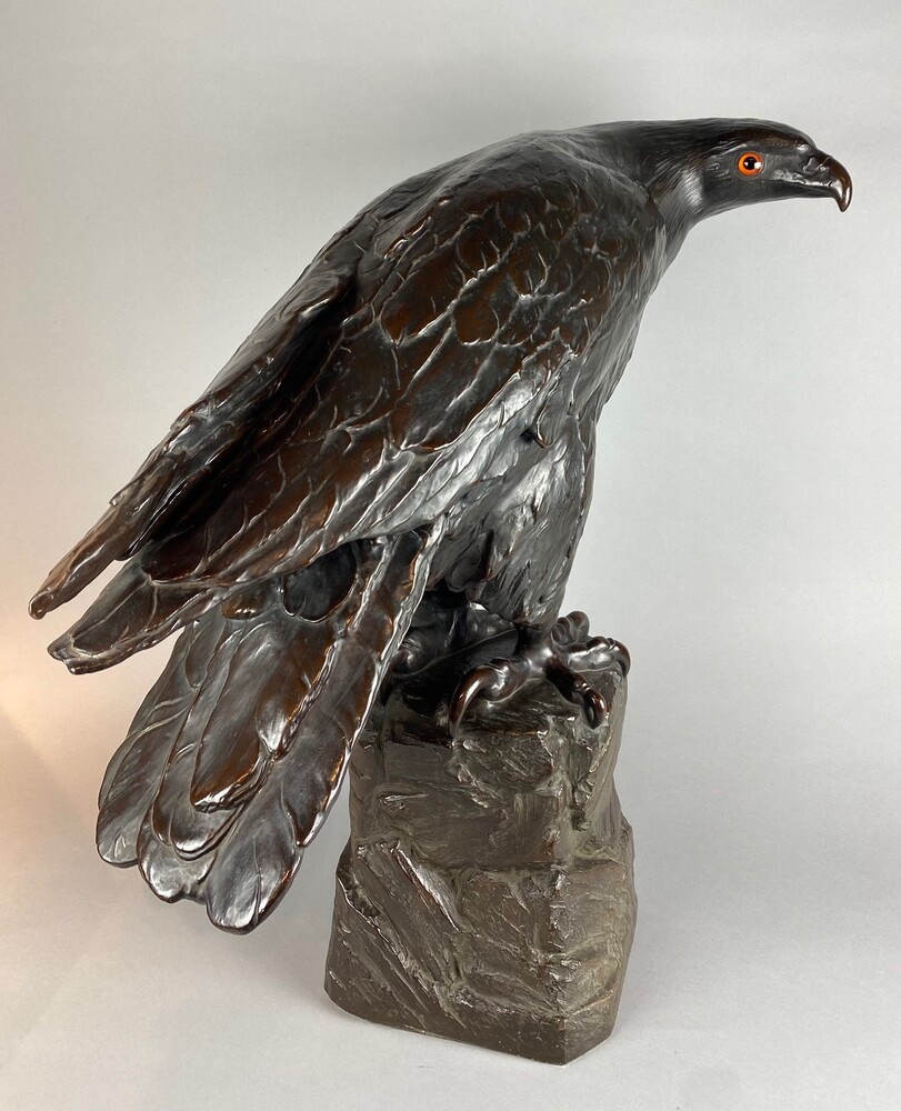 A life size terracotta bronze coloured sculpture of an eagle.