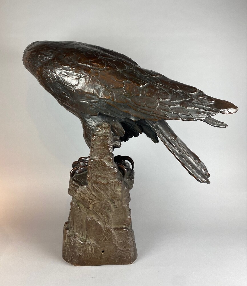 A life size terracotta bronze coloured sculpture of an eagle.