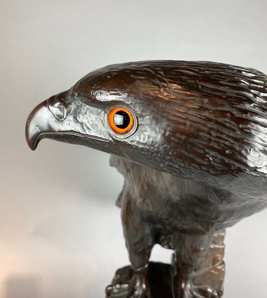 A life size terracotta bronze coloured sculpture of an eagle.