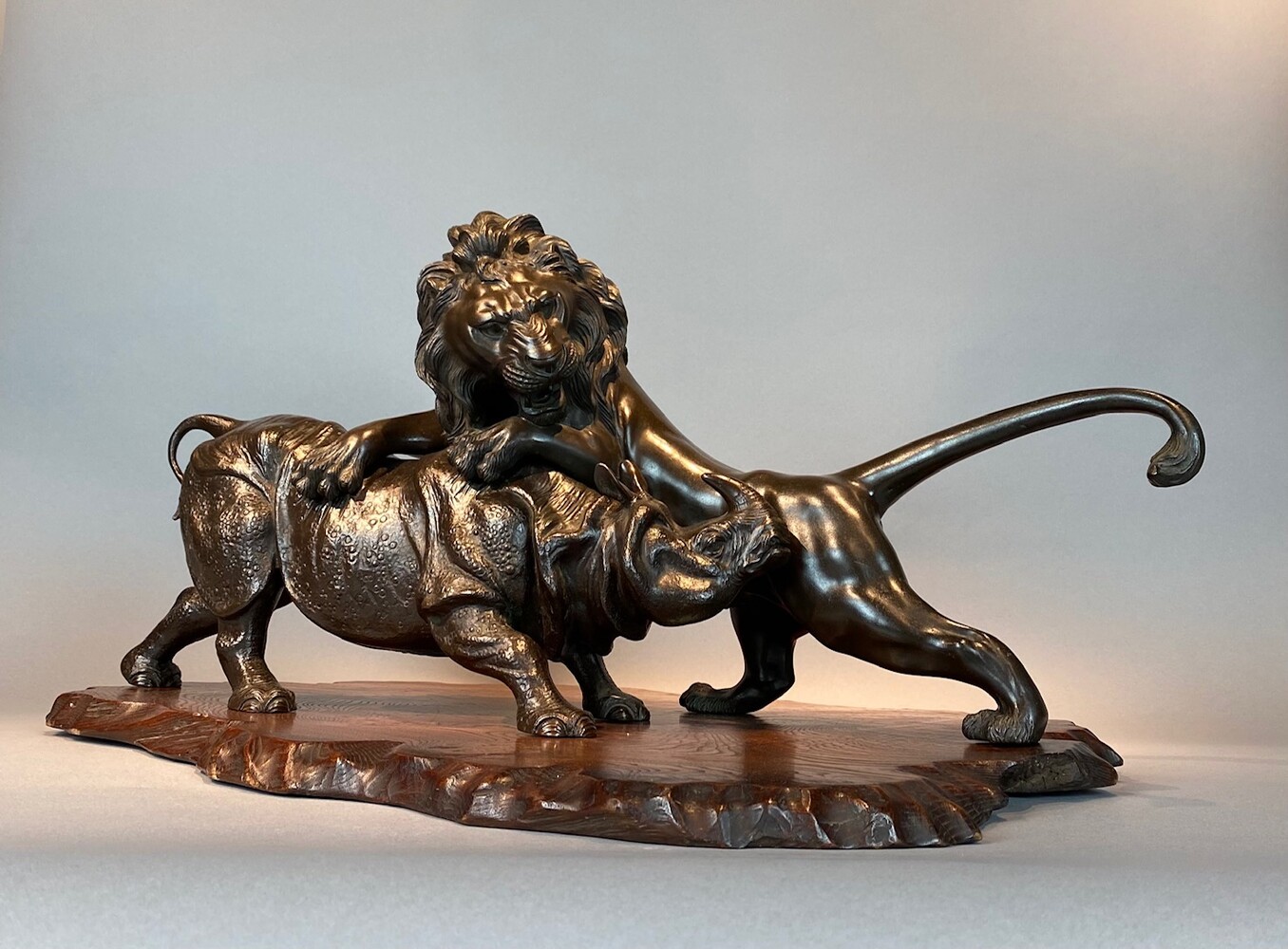 A rare Japanese bronze of a lion and an Asian rhino