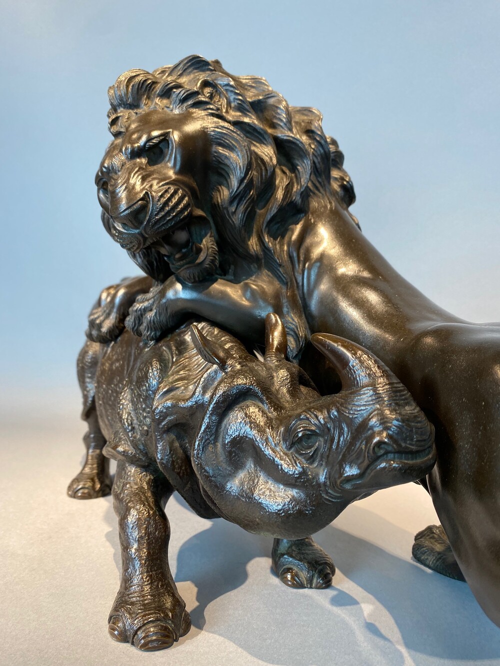 A rare Japanese bronze of a lion and an Asian rhino